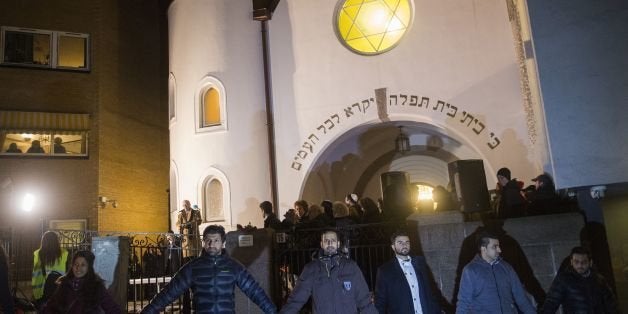 Norwegian Muslims create a human peace ring around the synagogue in Oslo, Norway on February 21, 2015. More than a 1,000 joined a peace vigil in Oslo Saturday, hosted by young Norwegian Muslims in a show of solidarity with Jews a week after fatal shootings in Denmark targeted a synagogue and free speech seminar. AFP PHOTO / FREDRIK VARFJELL (Photo credit should read Fredrik Varfjell/AFP/Getty Images)