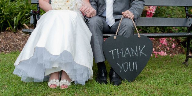 Bride & groom with Thank You sign