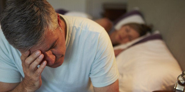 Man Awake In Bed Suffering With Insomnia Late At Night