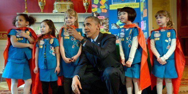 US President Barack Obama poses with girl scouts from Tulsa, Oklahoma during the 2015 White House Science Fair March 23, 2015 in Washington, DC. The fair celebrates student winners who created projects to illustrate mastery of science, technology, math or engineering. AFP PHOTO/BRENDAN SMIALOWSKI (Photo credit should read BRENDAN SMIALOWSKI/AFP/Getty Images)