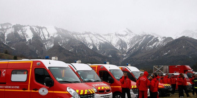 Rescue workers stand by ambulances at Seyne les Alpes, French Alps, Tuesday, March 24, 2015. A Germanwings passenger jet carr