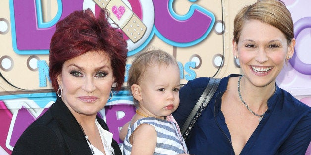 LOS ANGELES, CA - SEPTEMBER 26: (L-R) Television personality Sharon Osbourne, granddaughter Pearl Osbourne, and daughter-in-law Lisa Osbourne attend Disney Junior's 'Doc McStuffins' Doc Mobile tour at The Grove on September 26, 2013 in Los Angeles, California. (Photo by Imeh Akpanudosen/Getty Images)