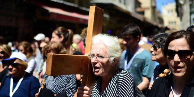 JERUSALEM, ISRAEL - APRIL 18 : Christians walk along the Via Dolorosa (Way of Suffering) to commemorate the crucifixion and death of Jesus Christ on the hill of Golgotha during the Good Friday in Jerusalem's Old City, Israel on April 18, 2014. (Photo by Salih Zeki Fazlioglu/Anadolu Agency/Getty Images)