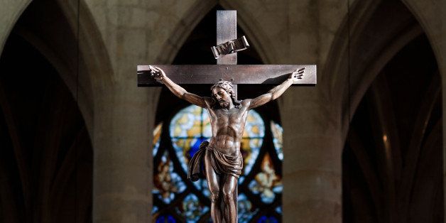 Statue of Jesus Christ on Cross enlightened by sunlight in Saint Ãtienne du Mont Basilica, Paris.