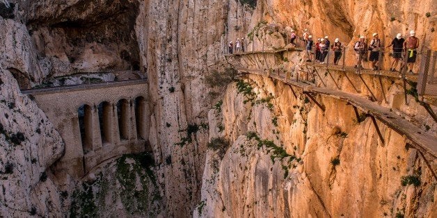 MALAGA, SPAIN - APRIL 01: Tourists walk along the 'El Caminito del Rey' (King's Little Path) footpath on April 1, 2015 in Malaga, Spain. 'El Caminito del Rey', which was built in 1905 and winds through the Gaitanes Gorge, reopened last weekend after a safer footpath was installed above the original. The path, known as the most dangerous footpath in the world, was closed after two fatal accidents in 1999 and 2000. The restoration started in 2011 and reportedly cost 5.5 million euros. (Photo by David Ramos/Getty Images)