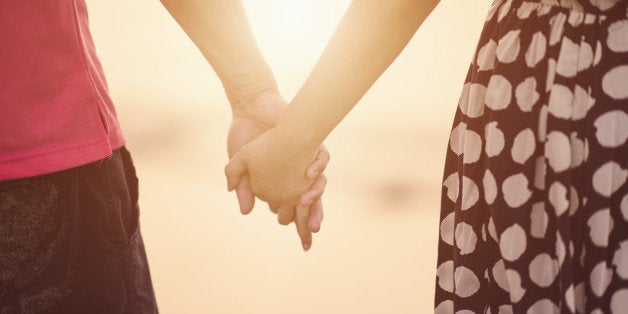 Young couple holding hands.