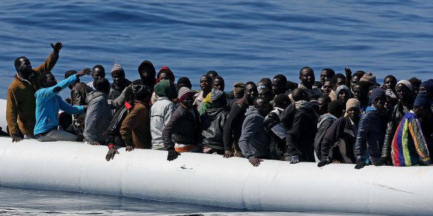In this photo made available Thursday, April 23, 2015, migrants crowd and inflatable dinghy as rescue vassel " Denaro " (not in picture) of the Italian Coast Guard approaches them, off the Libyan coast, in the Mediterranean Sea, Wednesday, April 22, 2015. Italy pressed the EU on Wednesday to devise robust steps to stop the deadly tide of migrants crossing the Mediterranean, including considering military intervention against smugglers and boosting U.N. refugee offices in countries bordering Libya. (Alessandro Di Meo/ANSA via AP Photo) ITALY OUT