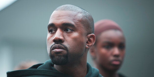 Kanye West appears with models during the showing of his Yeezy Boost shoe line for Adidas on Thursday, Feb. 12, 2015, during Fashion Week in New York. (AP Photo/Bebeto Matthews)