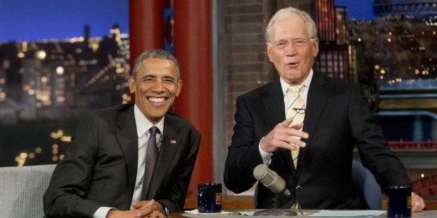 President Barack Obama with host David Letterman talk during a break at a taping of CBS' The Late Show with David Letterman a