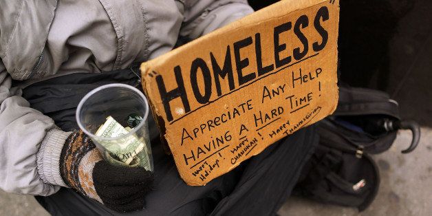 NEW YORK, NY - DECEMBER 04: A person in economic difficulty holds a homemade sign asking for money along a Manhattan street on December 4, 2013 in New York City. According to a recent study by the by the United States Department of Housing and Urban Development, New York City's homeless population increased by 13 percent at the beginning of this year. Despite an improving local economy, as of last January an estimated 64,060 homeless people were in shelters and on the street in New York. Only Los Angeles had a larger percentage increase than New York for large cities. (Photo by Spencer Platt/Getty Images)