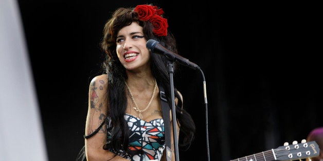 British singer, Amy Winehouse performs at the V Festival, near Chelmsford, England, Sunday, Aug. 17, 2008, after which, according to her father, Mitch Winehouse, she will play one more gig before taking an extended break from playing live after Sept. 6. (AP Photo/Joel Ryan)