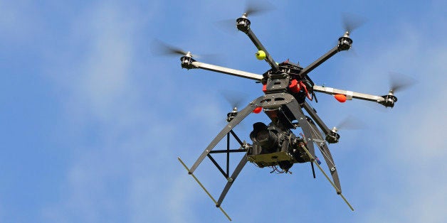 Digital camera (dslr) on a flying Unmanned Aerial Vehicle (UAV or Drone), with six rotors, used here for aerial photography o