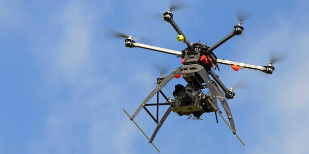 Digital camera (dslr) on a flying Unmanned Aerial Vehicle (UAV or Drone), with six rotors, used here for aerial photography or filming, France