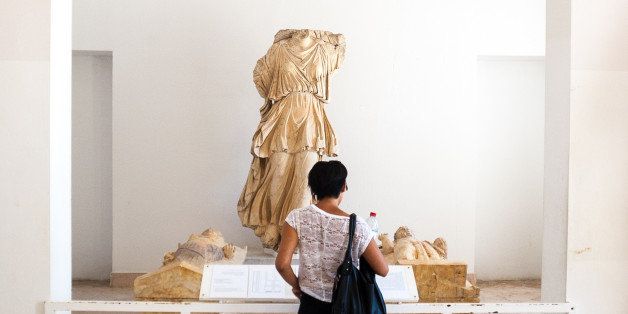 [UNVERIFIED CONTENT] Girl looking at a statue at the Bardo Museum in Tu