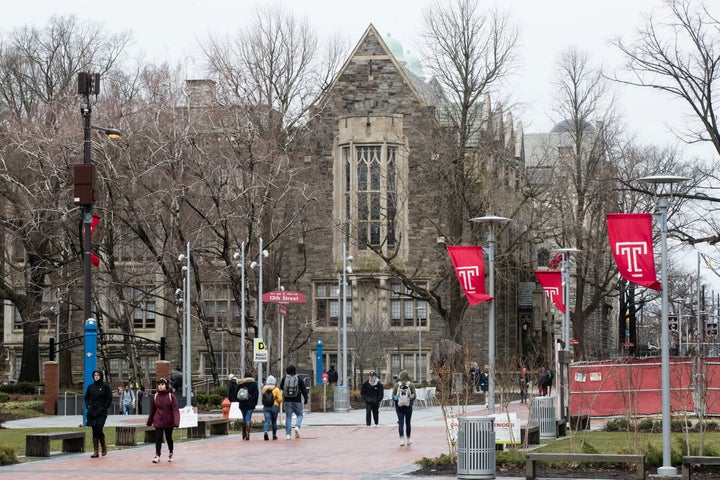 People walk on the Temple University campus in Philadelphia on Friday. Philadelphia health officials say scores of people have contracted mumps at the school.