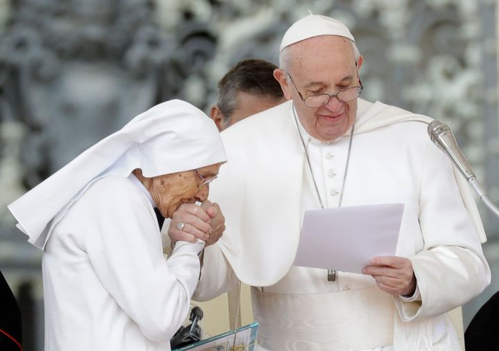 85-year-old sister Maria Concetta Esu kisses the hand of Pope Francis as he presents her with a Pro Ecclesia et Pontifice award during his weekly general audience, in St. Peter's Square, at the Vatican in March 