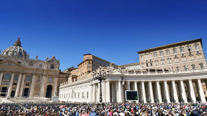 Pope Francis (second window from top right) addresses worshippers at St.Peter's square during the weekly Angelus prayer on Ma