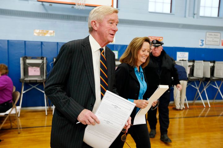 Former Massachusetts Gov. Bill Weld and his wife, Leslie Marshall, hold ballots before casting their votes at the John F. Kennedy Elementary School in Canton, Massachusetts.