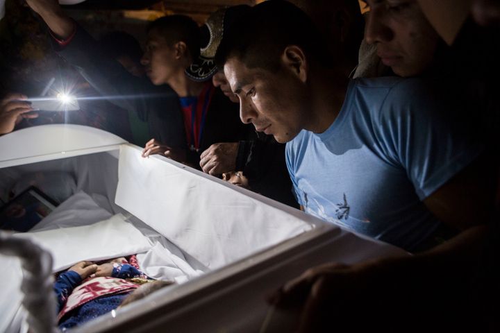Family members pay their final respects to 7-year-old Jakelin Caal Maquin during a memorial service in her grandparent's home in San Antonio Secortez, Guatemala, 
