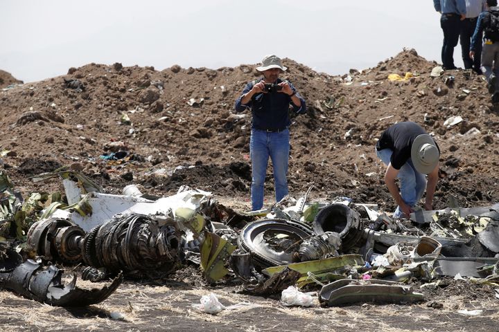 American civil aviation and Boeing investigators search through the debris at the scene of the Ethiopian Airlines Flight ET 302 plane crash, near the town of Bishoftu, southeast of Addis Ababa, Ethiopia.