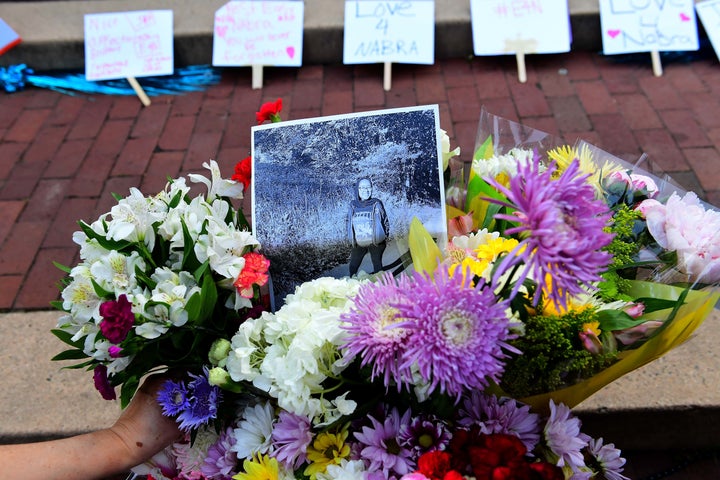 Friends, family, neighbors and strangers bring flowers to a vigil for Nabra Hassanen at Lake Anne Plaza near Reston, Virginia, on June 21, 2017.