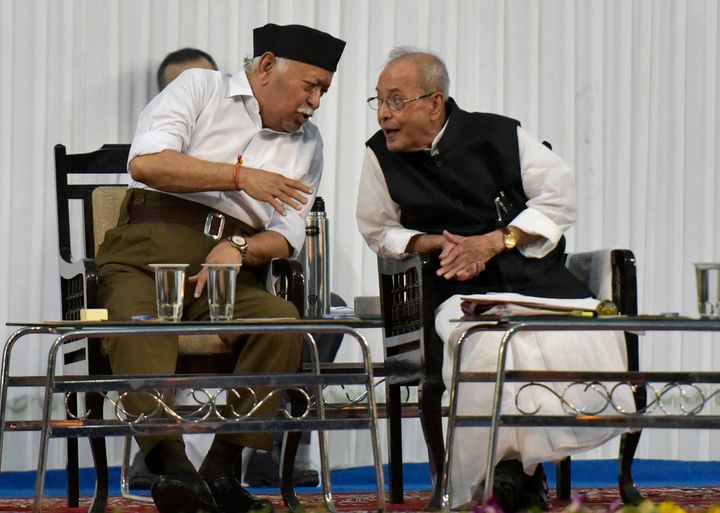 Former President Pranab Mukherjee, right, speaks with Mohan Bhagwat, RSS Chief, in July 2018. In recent years, the RSS has sought to project a more inclusive image by inviting prominent personalities to its events as well as holding special lecture sessions like the one in which Bhagwat gave three lectures over as many days in Delhi last year to reach out to skeptics. 