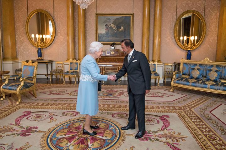 The Sultan of Brunei meeting Queen Elizabeth at Buckingham Palace last year. He was awarded an honorary knighthood in 1992.