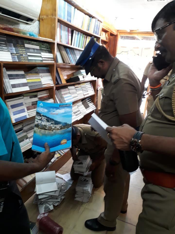 Election Commission Flying squad and police officials seize the copies of the book 'Rafale: The Scam That Shook The Nation' from Bharathi Puthakalayam's bookstore in Chennai on Tuesday. 