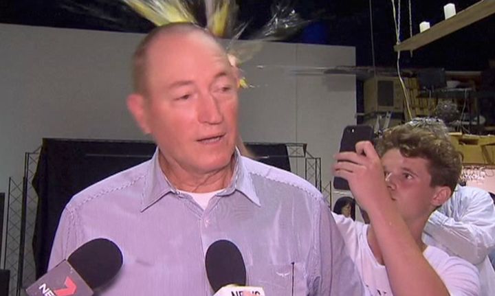 In this image made from video, a teenager breaks an egg on the head of Senator Fraser Anning while he holds a press conference, Saturday, March 16, 2019, in Melbourne, New Zealand. 