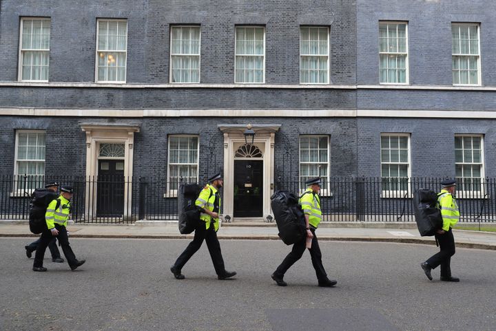 Police officers carry equipment through Downing Street in London, as multiple Brexit protests gathered in Parliament Square on March 29.