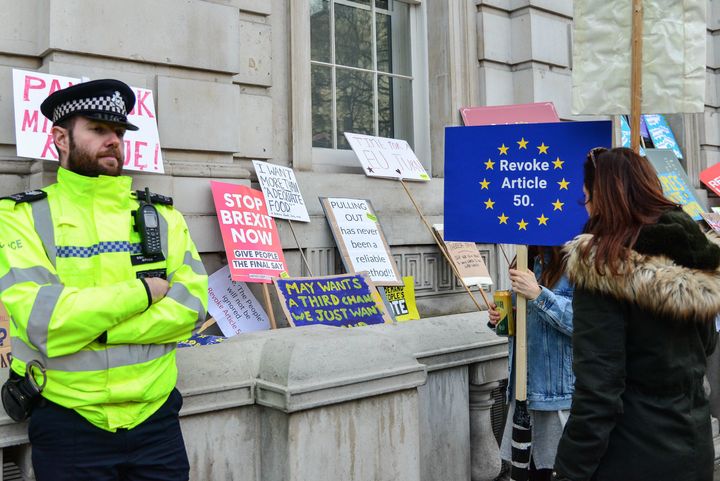 A police officer stands guard during the 'Put it to the people' anti-Brexit march on April 23.