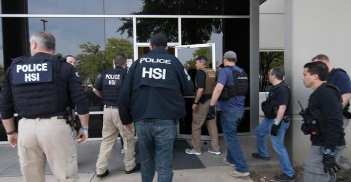 ICE Homeland Security Investigations agents conduct a workplace raid Wednesday in North Texas, the largest such raid in over a decade.