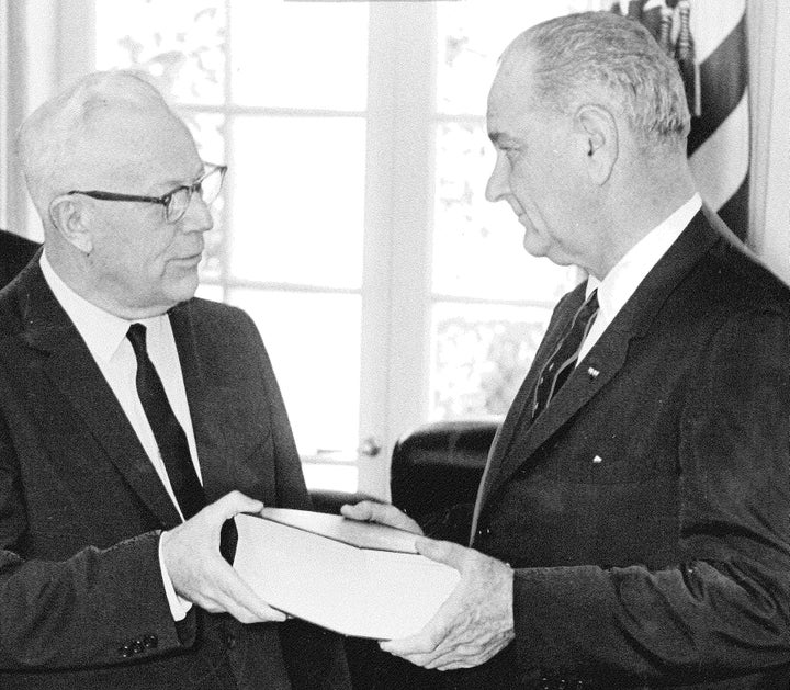 Chief Justice Earl Warren presenting the report of the Warren Commission to President Lyndon Johnson.