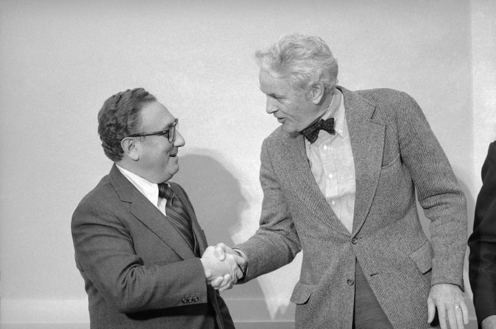 Secretary of State Henry Kissinger, left, shakes hands with Chairman Otis Pike (D-N.Y.) of the House Intelligence Committee i