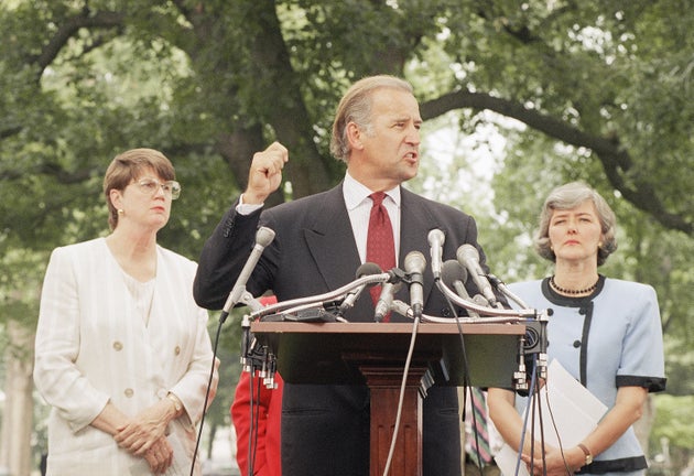 Sen. Joseph Biden (D-Del.), flanked by Attorney General Janet Reno, left, and Rep. Patricia Schroeder...
