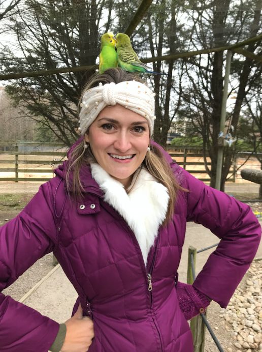 Ella poses with parakeets in November 2018.