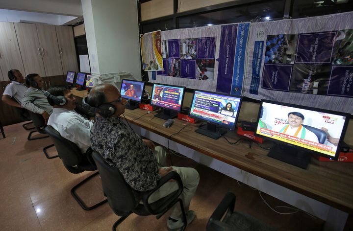Election staff watch TV channels to monitor Model Code of Conduct on behalf of the Election Commission inside a district collector's office ahead of India's general election, in Ahmedabad, March 14, 2019.