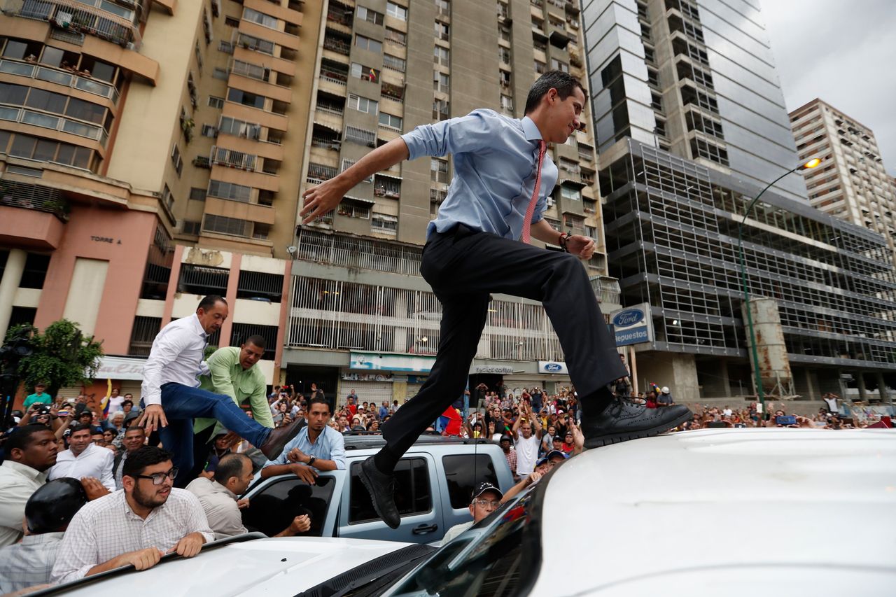 Juan Guaidó, the Venezuelan opposition politician, jumps across cars during a protest in Caracas