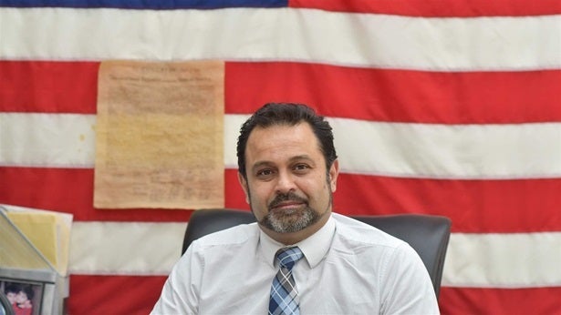 Mohammad Razvi, founder of the Council of Peoples Organization, at his desk in the organization’s headquarters in the Little