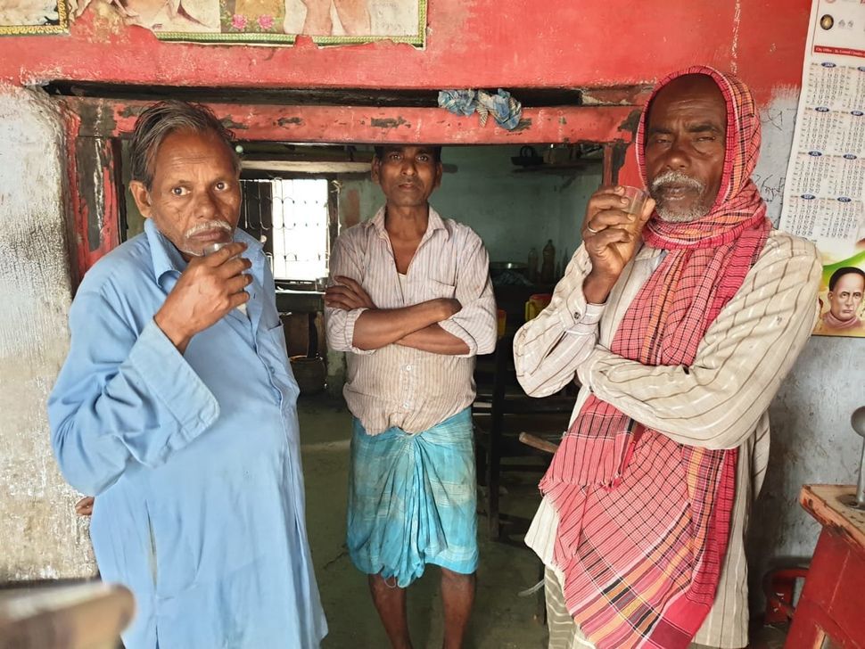 Ghulam Mohammad (centre) at his tea stall.