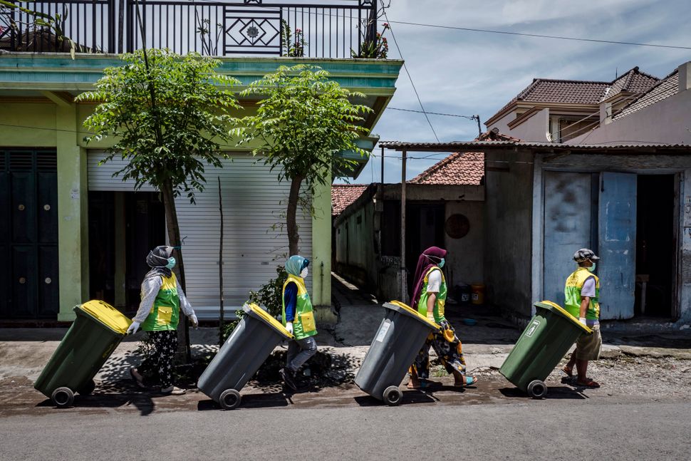 The Warriors of Waste go door to door collecting garbage from the community at Tembokrejo village in