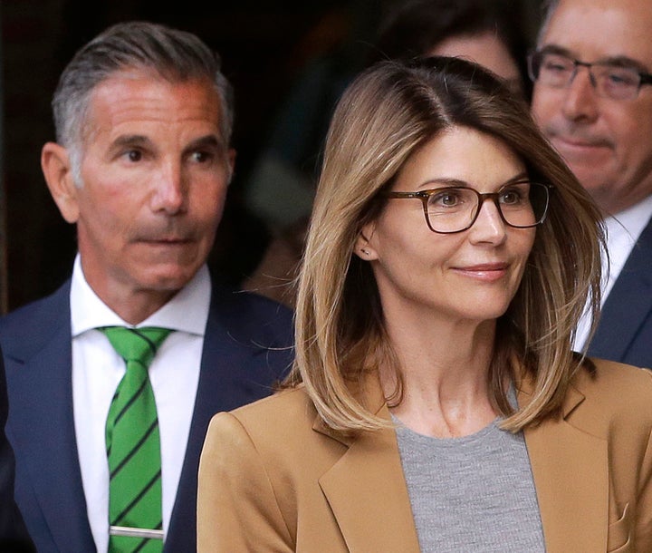 Actress Lori Loughlin, front, and her husband, clothing designer Mossimo Giannulli, left, depart federal court in Boston on April 3, 2019, after facing charges in a nationwide college admissions bribery scandal.