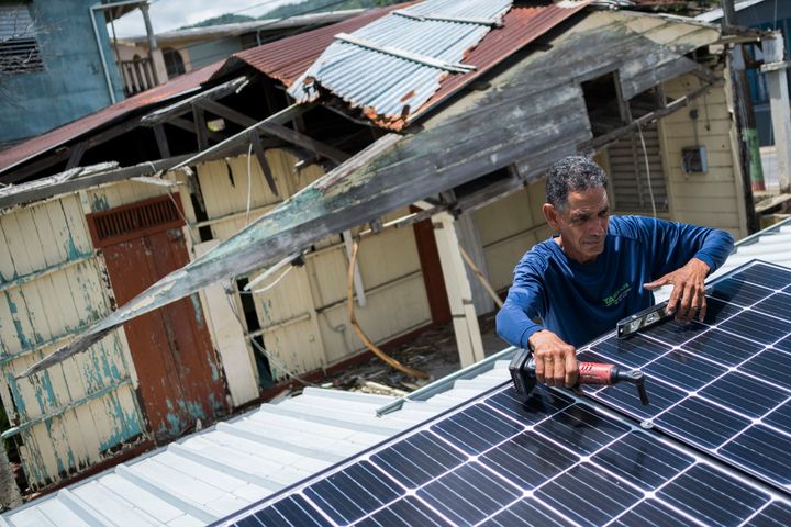 Julio Rosario installs a solar system on his home in Adjuntas, Puerto Rico.