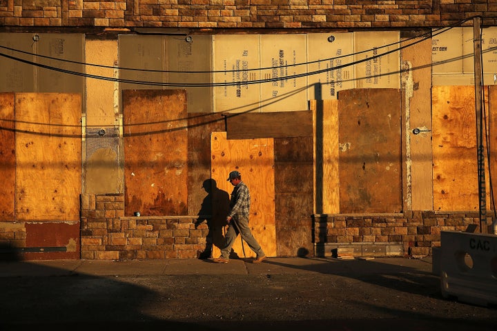 A man passes a building in the Rockaways still under construction a year after the disastrous 2012 Superstorm Sandy.
