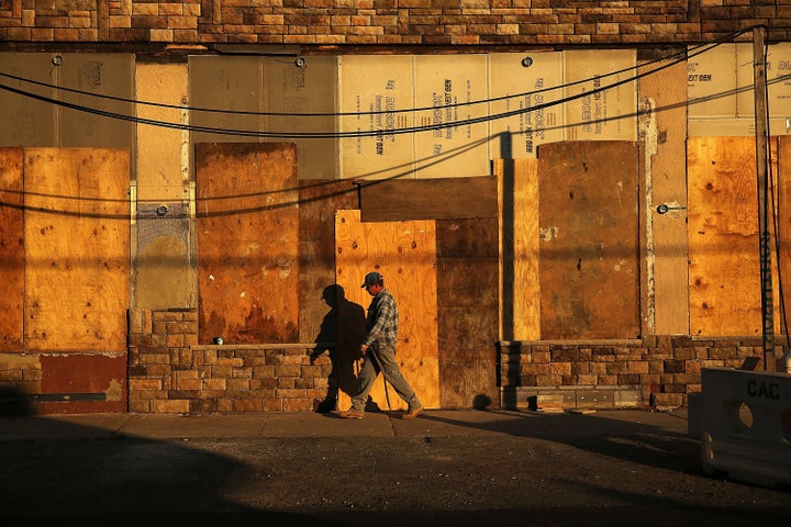 A man passes a building in the Rockaways still under construction a year after the disastrous 2012 Superstorm Sandy. 