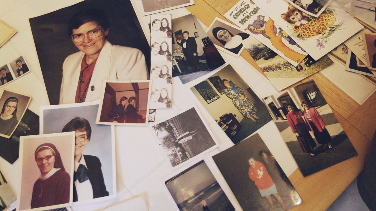 Photos of Sister Eileen Shaw are laid out on a table inside Trish Cahill's home in Lancaster, Pennsylvania.