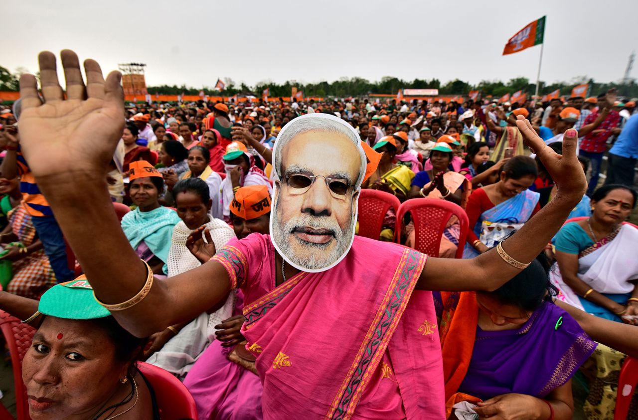 A woman wearing a mask of Prime Minister Narendra Modi dances at an election ally organized by the Bharatiya Janata Party in the northeastern state of Assam on April 5, 2019.