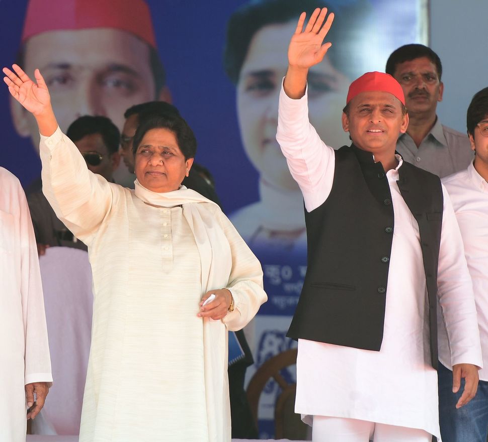 BSP president Mayawati and Samajwadi Party president Akhilesh Yadav wave at the first joint rally in Deoband on April 7, 2019.