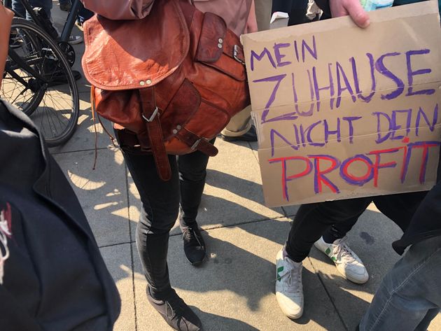 A protester at Saturday's march in Berlin carries a placard reading “My Home, Not Your