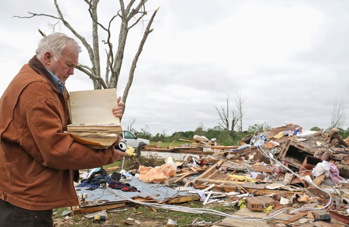 Robert Scott looks through a family Bible that he pulled out of the rubble after a tornado touched down near Hamilton, Mississippi on Sunday.
